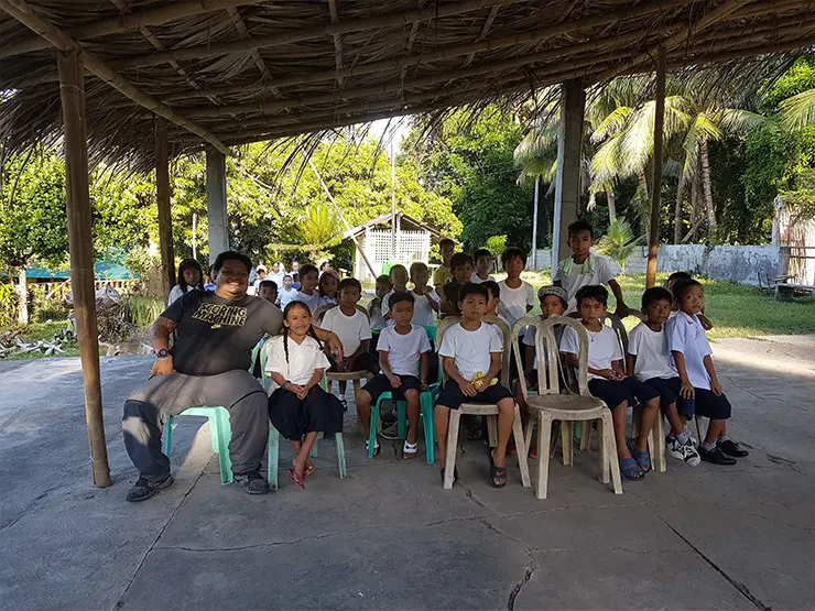 Sales Rain Admin. & Facilities Manager, Mr. Billy Espina with the school children Sales Rain Admin & Facilities Manager, Mr. Billy Espina with the school children